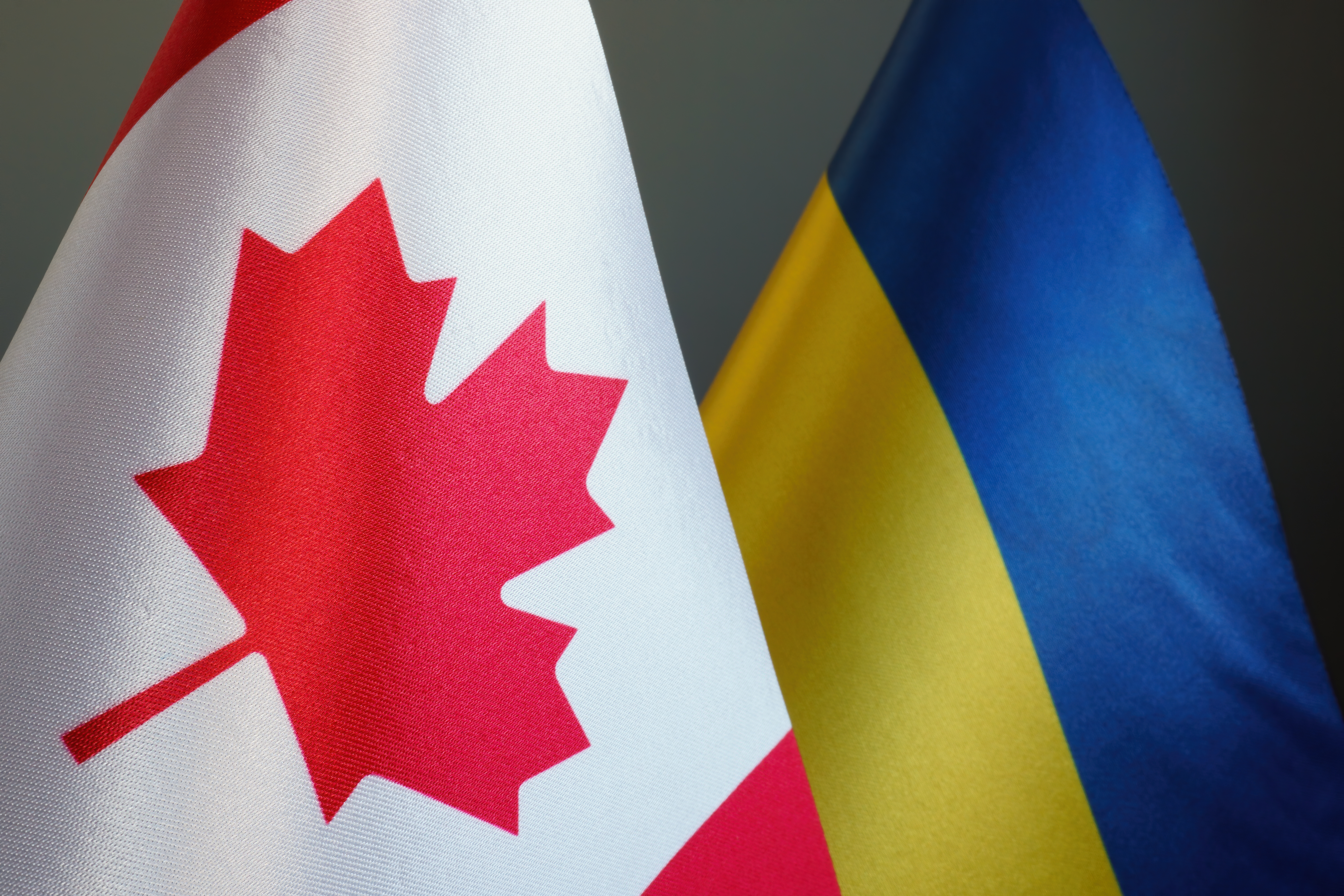 Flags of Canada and Ukraine as symbol of cooperation.