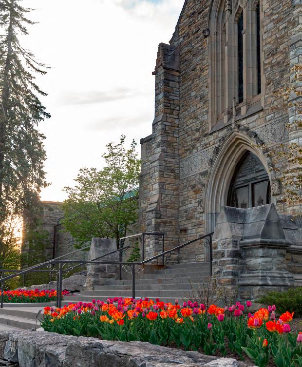 Beechwood Mausoleum with purple, red and orange tulips