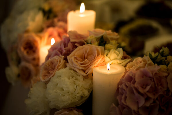 beautiful flowers of different colors and candles on the table